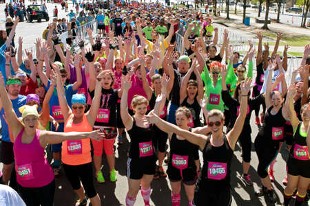 Atlanta, GA, USA - April 5, 2014   A throng of excited runners gathered at start line, jubilantly waves to camera at the Ridiculous Obstacle Challenge  ROC  5k race  のeditorial素材