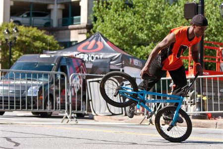 Athens, GA, USA - April 26, 2014:  A young male practices his flatland tricks before the start of the BMX Trans Jam competition on the streets of downtown Athens.のeditorial素材