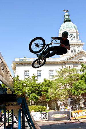 Athens, GA, USA - April 26, 2014:  A teenage boy practices his ramp jumps before start of the BMX...