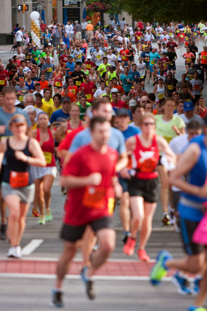 Atlanta, GA, USA - July 4, 2014:  Thousands of runners make their way down Peachtree Street on their way to the finish line of the Peachtree Road Raceのeditorial素材