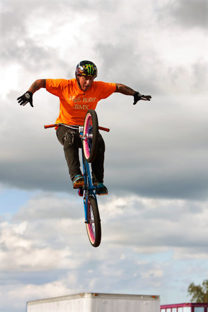 Hampton, GA, USA - September 27, 2014:  A young man with the High Roller BMX club takes his hands off the handlebars while performing a midair BMX stunt at the Georgia State Fair.のeditorial素材