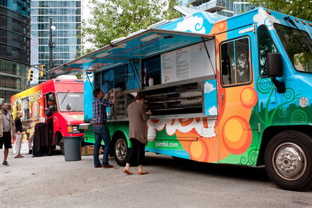 Atlanta, GA, USA - October 16, 2014:  Customers order meals from a popular food truck during their...