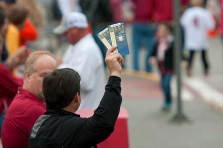 Atlanta, GA, USA - December 6, 2014:  An unidentified man tries to sell two tickets to the SEC Championship game, outside the Georgia Dome.のeditorial素材