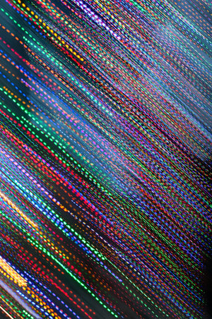 Pan of colorful holiday lights creates electric rainの写真素材