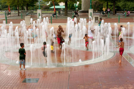 Atlanta, GA, USA - September 6, 2014:  Motion blur of families and kids getting soaking wet while playing in the fountain at Centennial Park in Atlanta.のeditorial素材