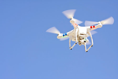Decatur, GA, USA - October 4, 2014:  A drone hovers against a blue sky, as part of a demonstration for patrons at the annual Maker Faire Atlanta.のeditorial素材