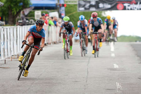Athens, GA, USA - April 25, 2015:  Teenage cyclists compete in an amateur race on the streets of downtown Athens, in the annual Twilight Criterium bike races on April 25, 2015 in Athens, GA.のeditorial素材