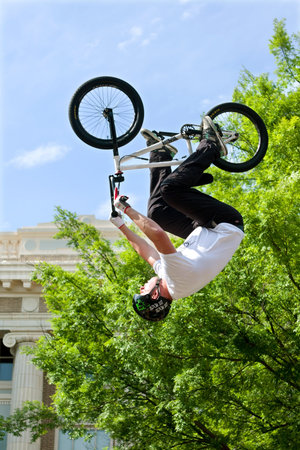 Athens, GA, USA - April 25, 2015:  Young adult performs upside-down stunt in the pro BMX competition at the annual Athens Twilight Criterium, on April 25, 2015 in Athens, GA.のeditorial素材
