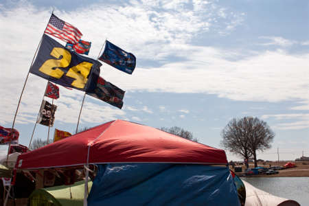 Hampton, GA, USA - February 28, 2015:  Fans fly the flags of their favorite NASCAR drivers as they camp in tents outside Atlanta Motor Speedway before a weekend of races.のeditorial素材