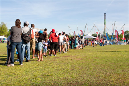Atlanta, GA, USA - April 11, 2015:  Parents and kids stand in a very long line waiting their turn...