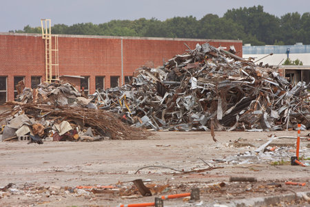 Debris piles of twisted metal and junk are stacked high at the demolition site of an auto assembly...