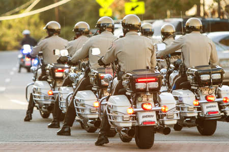 Canton, GA, USA - October 17, 2015:  A group of local motorcycle police officers in the Sheriff's Department ride through town in unison as part of the Cherokee Zombie Fest in Canton, GA.のeditorial素材