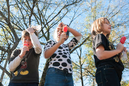 Atlanta, GA, USA - November 14, 2015:  Kids hold their heads as they experience brain freeze while competing in a popsicle eating contest at the King of Pops Festival in Atlanta, GA on November 14, 2015.のeditorial素材