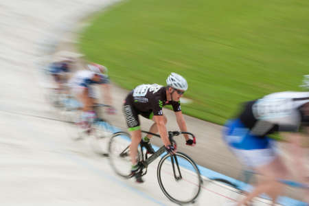 East Point, GA, USA - August 29, 2015:  A group of pro cyclists motion blur while sprinting in a race at the Dick Lane Velodrome in East Point, GA on August 29, 2015.のeditorial素材