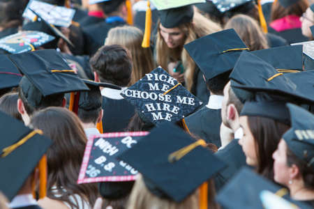 Athens, GA, USA - May 13, 2016:  A University of Georgia graduate wears a mortar board that says "pick me, choose me, hire me" at graduation activities on May 13, 2016 in Athens, GA.のeditorial素材