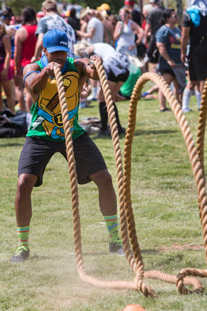 Atlanta, GA, USA - July 16, 2016:  A man does a rope whip workout with the tug-of-war ropes while waiting for the next session to begin at Atlanta Field Day, an event where adult teams play kid's games, on July 16, 2016 in Atlanta, Ga.のeditorial素材