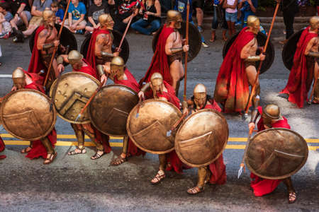Atlanta, Ga, USA - September 3, 2016:  Men dressed as Spartan warriors from the movie 300, strike a defensive pose with their shields and spears, as they walk in the annual Dragon Con parade on September 3, 2016 in Atlanta, GA.のeditorial素材