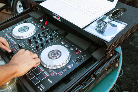 Atlanta, GA, USA - October 8, 2016:  A deejay adjusts the knobs on sophisticated sound equipment to enhance the audio and play rap music at the Atlanta Hip Hop Day, a free event open to the public in Woodruff Park, on October 8, 2016 in Atlanta, GA.のeditorial素材