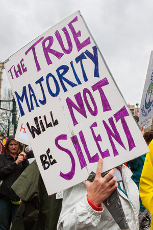 Atlanta, GA, USA - January 21, 2017:  A woman carries large sign that says The true majority will...