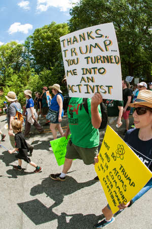 Atlanta, GA, USA - March 22, 2017:  A man holds up a sign that says "Thanks Trump...you turned me into an activist" as he takes part in the Atlanta March for Science near Candler Park on Earth Day on April 22, 2017 in Atlanta, GA.のeditorial素材