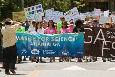 Atlanta, GA, USA - March 22, 2017:  People carry the Atlanta March for Science banner, as thousands line up behind to begin the march at Candler Park on Earth Day on April 22, 2017 in Atlanta, GA.のeditorial素材