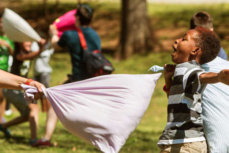 Atlanta, GA, USA - April 1, 2017:  A child avoids being hit by a pillow while taking part in International Pillow Fight Day at Grant Park on April 1, 2017 in Atlanta, GA.のeditorial素材