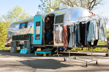 Atlanta, GA, USA - April 1, 2017:  A woman emerges from a mobile women's clothing store in a trailer...