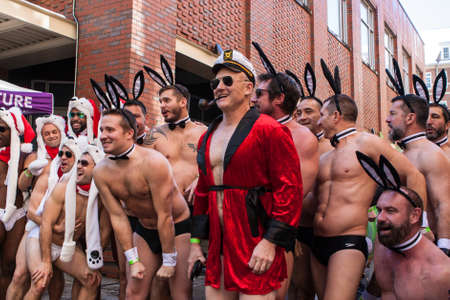 Atlanta, GA, USA - December 9, 2017:  A group of men wearing speedos and playboy bunny accessories, pose for a photo with a Hugh Hefner impersonator before the Santa Speedo Run, a charity fundraiser on December 9, 2017 in Atlanta, GA.のeditorial素材
