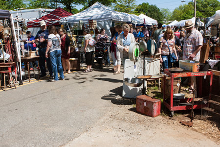 Braselton, GA, USA - April 28, 2018:  People walk and look at antiques on sale at the Braselton Antique Festival on April 28, 2018 in Braselton, GA.のeditorial素材
