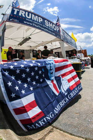Helen, GA, USA - June 2, 2018:  An assortment of Donald Trump and conservative merchandise sits on display at the Trump Shop, a popup outdoor store selling Trump apparel and other items in a parking lot on June 2, 2018 in Helen, GA.のeditorial素材