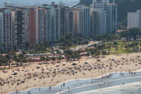 Sao Vicente, Brazil - July 8, 2018:  High-angle view of hundreds of people enjoying the beach on a Sunday at Sao Vicente, on July 8, 2018 in Sao Vicente, Brazil.のeditorial素材