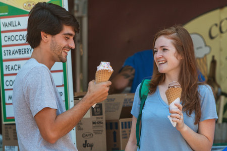 Atlanta, GA, USA - July 28, 2018:  A young couple smiles and laughs as they prepare to eat their...