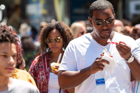 Atlanta, GA, USA - July 28, 2018:  A crowd of people walks and eats ice cream at the Atlanta Ice Cream Festival in Piedmont Park on July 28, 2018 in Atlanta, GA.のeditorial素材