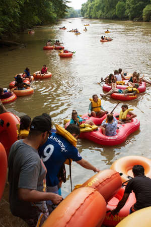 Duluth, GA / USA - July 14, 2018:  Groups of people put their innertubes and rafts in the Chattahoochee River to tube down the river at the Whatever Floats Your Boat event on July 14, 2018 in Duluth, GA.のeditorial素材