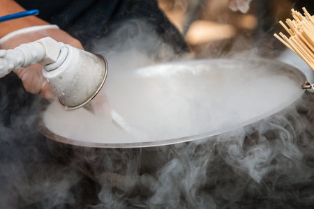 Hand mixes liquid nitrogen with other ingredients in a bowl to make a frozen treat at an Atlanta...