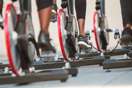 Atlanta, GA, USA - September 15, 2018:  Closeup of women's sneakers pedaling in unison as they participate in an outdoor spin class at the Pretty Girls Sweat Fest on September 15, 2018 in Atlanta, GA.のeditorial素材