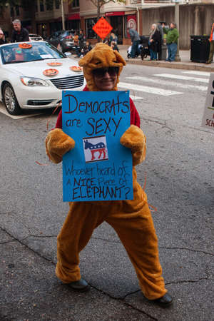 Decatur, GA, USA - October 27, 2018:  A woman in a costume holds a sign that says "Democrats Are Sexy" at the Haints and Saints Halloween Parade in Decatur, GA on October 27, 2018 in Decatur, GA.のeditorial素材