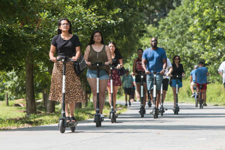 Atlanta, GA, USA - July 6, 2019:  Various people ride motorized scooters along the Atlanta Belt Line at the Old Fourth Ward Park, on July 6, 2019 in Atlanta, GA.のeditorial素材