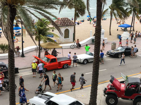 Ft. Lauderdale, Florida - May 25, 2019:  People look at vintage cars lined up on Highway A1A at the beach during a class cars show and festival during the Memorial Day holiday weekend on May 25, 2019 in Ft. Lauderdale, Florida.のeditorial素材