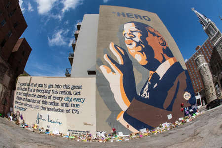 Atlanta, GA, USA - August 1, 2020:  Flowers, tributes and messages sit at the base of the iconic John Lewis mural on Auburn Avenue two days after his funeral, on August 1, 2020 in Atlanta, GA.のeditorial素材