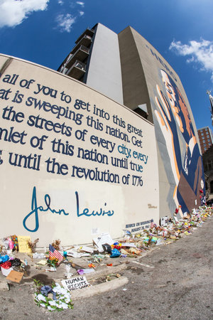 Atlanta, GA, USA - August 1, 2020:  Flowers, tributes and messages sit at the base of the iconic...
