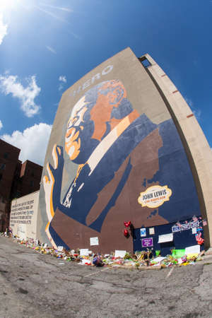 Atlanta, GA, USA - August 1, 2020:  Flowers, tributes and messages sit at the base of the iconic John Lewis mural on Auburn Avenue two days after his funeral, on August 1, 2020 in Atlanta, GA.のeditorial素材