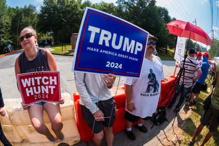 Atlanta, GA / USA - August 24, 2023:  Trump supporters hold signs as they await Donald Trump's...