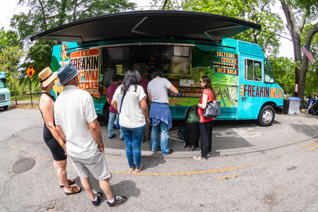Atlanta, GA / USA - April 29, 2023:  Fisheye lens shot shows people standing in line at a food truck at the annual Inman Park Festival, on April 29, 2023 in Atlanta, GA.のeditorial素材