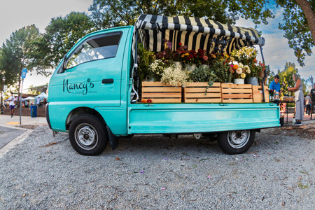 Suwanee, GA / USA - August 4, 2023:  A cute flower truck full of flowers for sale sits parked at a...