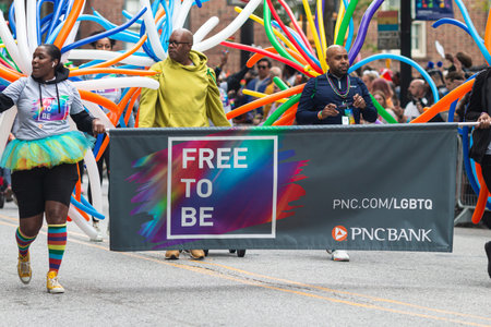Atlanta, GA / USA - October 15, 2023:  PNC Bank employees wear colorful balloons while walking in...