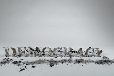 Wood letters spell out the word democracy against a white seamless background. The letters are burned and muddied.の写真素材