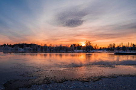 Sunset over a snowy and cold varmland, Swedenの写真素材