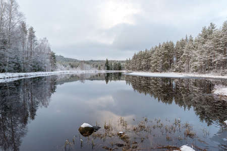 A snowy landscape overlooking water and iceの写真素材