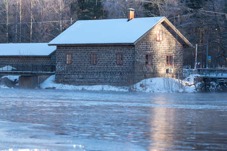stone house standing beside waterの写真素材